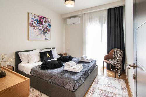a bedroom with a bed with towels on it at Alexandra Boutique Residence VILLAS in Alexandroupoli