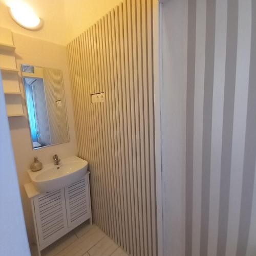 a bathroom with a sink and a mirror at Lucia apartman in Kaposvár
