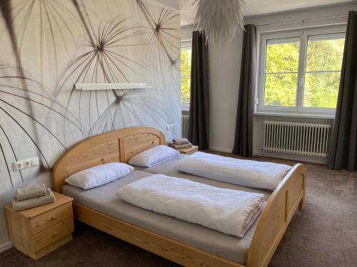 a bedroom with two beds and a wall at Pension Straßl in Andorf