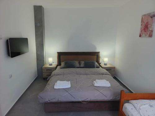 a bedroom with a bed with two towels on it at Apartman Kutak in Pirot