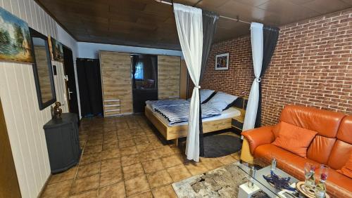 a bedroom with a bed and a couch in a room at Apartment Wildgrund in Siegen