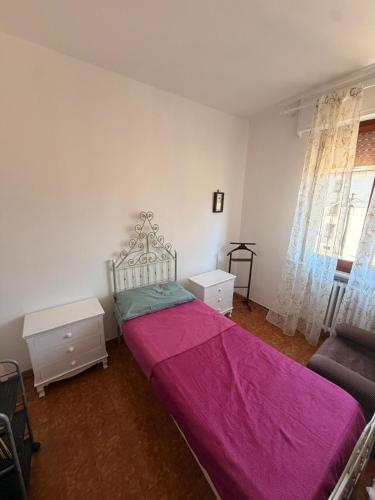 a bedroom with a large bed with a pink blanket at Casa di Mary in Pontremoli