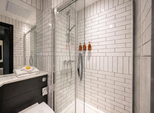 a bathroom with a shower and a toilet and a sink at The Hendrick Smithfield in Dublin
