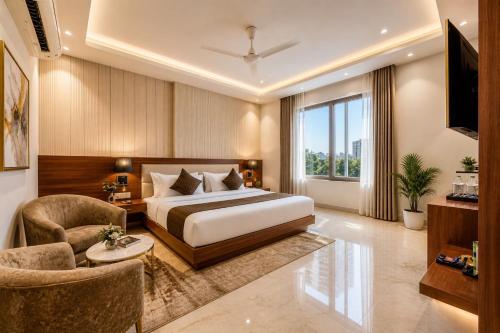 a bedroom with a bed and a couch and a chair at Corporate Terminal Stay By Velocity Hotels Delhi IGI Airport Terminal 3 With Free Airport Pickup in New Delhi