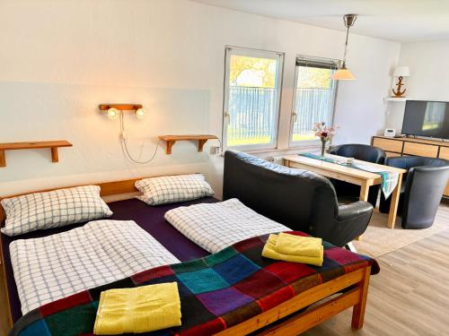 a living room with a bed and a couch at Ferienhäuser Vogelsang in Sagard