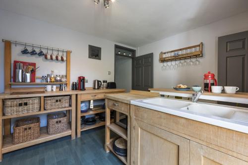 a kitchen with a sink and a counter top at Ace Cottage in Lymington