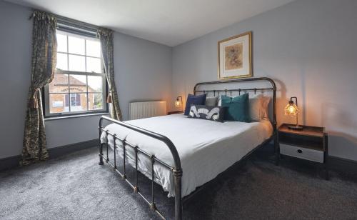a bedroom with a bed and a window at Ace Cottage in Lymington