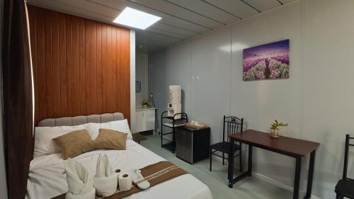 a bedroom with a bed and a table and a desk at Crespina Private House in General Luna