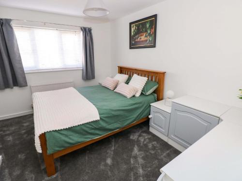 a small bedroom with a bed and a window at The Gower Gateway in Swansea