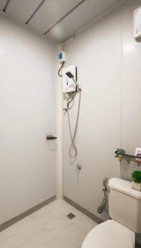 a bathroom with a shower and a toilet at Crespina Private House in General Luna