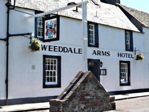 a white building with the words weedible arms hotel at Tweeddale Arms Hotel in Gifford