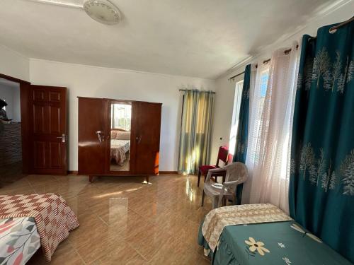 a room with two beds and a mirror in it at Shalom Villa 2 in Vacoas