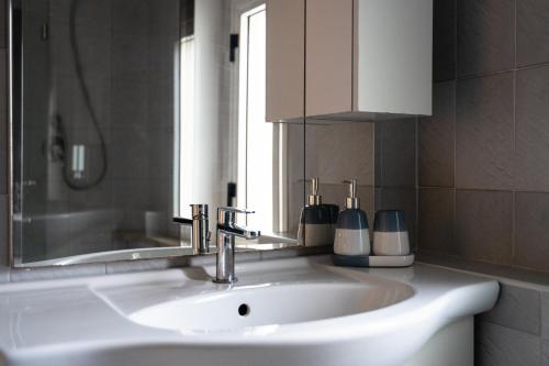 a bathroom with a white sink and a mirror at Casa 1941 in Conversano