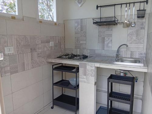 a kitchen with a sink and a counter top at Una terrazza sul mare in Agropoli