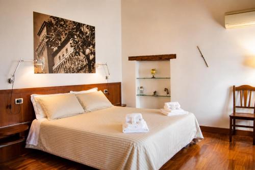 a bedroom with a bed with two towels on it at Boutique Rooms 3 0 in Ferrara