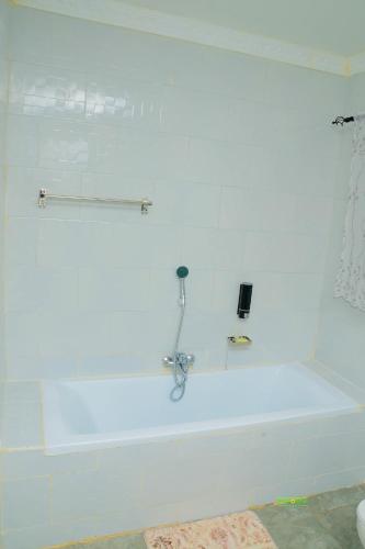 a white bath tub in a bathroom at On Edward in Bulawayo