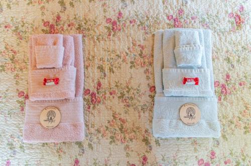 two towels are sitting on top of a wall at the Treehouse Project in Patra