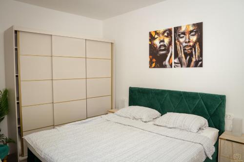 a bedroom with a bed and a poster on the wall at Island Pearl in Mali Lošinj
