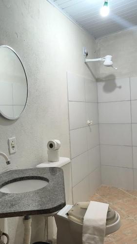a bathroom with a sink and a toilet and a mirror at Casa da Di in Lençóis