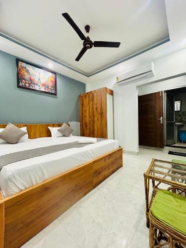 a bedroom with two beds and a ceiling fan at Parvati home stay near by ramjhula,luxmanjhula in Rishīkesh