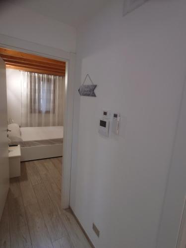 a room with a bathroom with a bed and a door at Angolo Del Paradiso in Chioggia