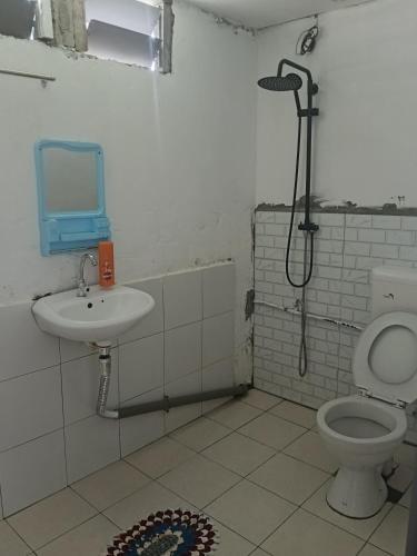 a bathroom with a toilet and a sink at Mulu D Cave Homestay Room 2 in Mulu