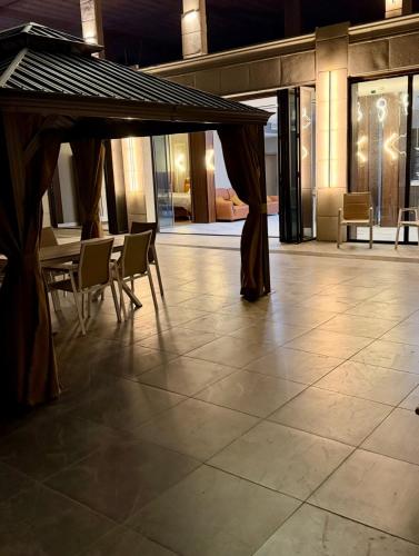a patio with a table and chairs in a building at Grape Resort منتجع وشاليهات عنب in Ajloun