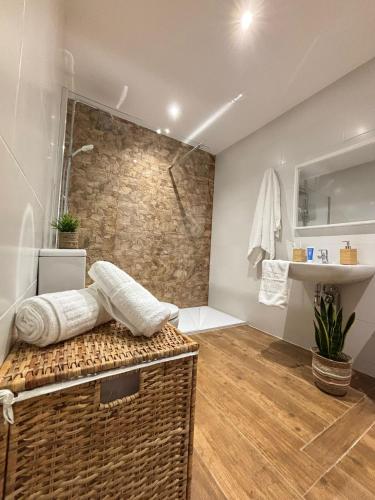 a bathroom with a walk in shower and a sink at A Taberniña in O Pedrouzo