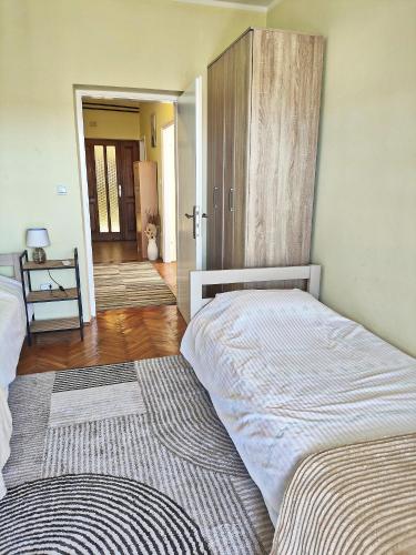 a bedroom with two beds and a door to a hallway at Lana 38 in Savina