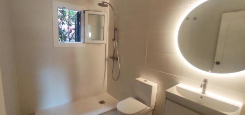 a bathroom with a toilet and a sink and a mirror at Menorca beach in Cala Galdana