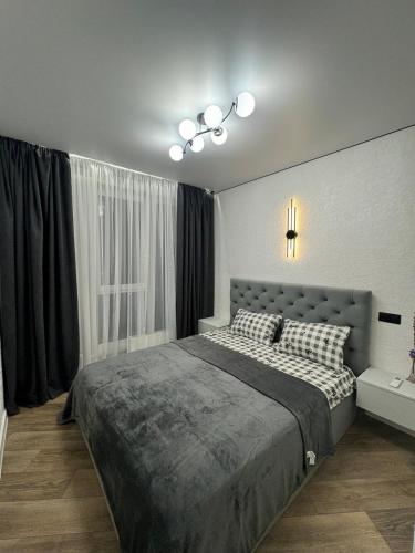 a bedroom with a large bed and a window at ЖК Акварель 8 in Odesa