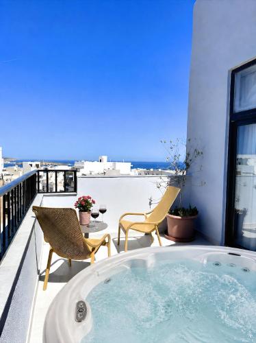 a jacuzzi tub on a balcony with a view at For Rest Aparthotel in St. Paul's Bay