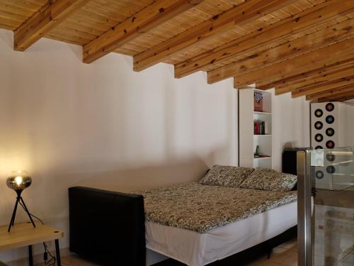 a bedroom with a bed in a room with wooden ceilings at Casa Da Liberdade in Alte