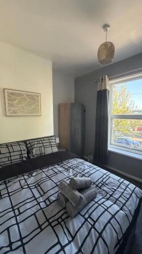 a bedroom with a bed with two towels on it at Central 2 Bed House in Huddersfield