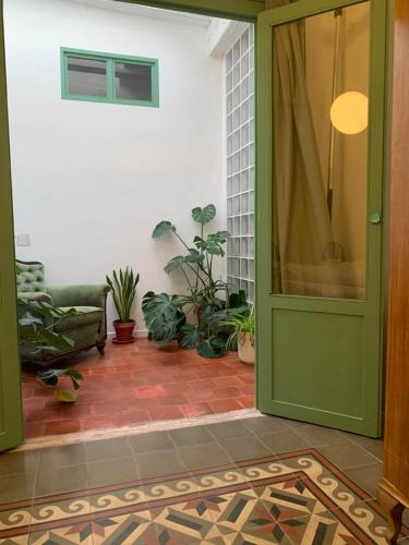 a green door in a room with plants at Apartamento El Tozal in Teruel