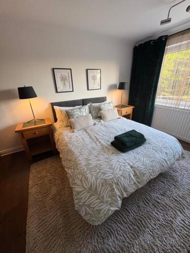 a bedroom with a bed with a green bag on it at Pippins in Tiverton