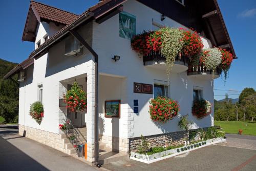 a white building with flower boxes on it at House Pox 2 in Plitvička Jezera