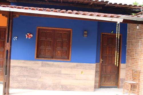 a blue wall with two doors on a house at Hotel Club Resort Místico in Coroaci