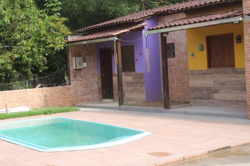 a house with a swimming pool in front of it at Hotel Club Resort Místico in Coroaci