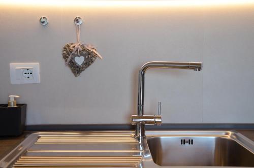 a kitchen sink with a heart ornament on the wall at Sea View Villa, 4-6 Guests in Cupra Marittima