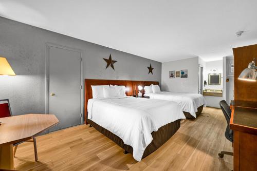 a hotel room with two beds with white sheets at Harvest Drive Family Inn - Renovated Rooms in Gordonville