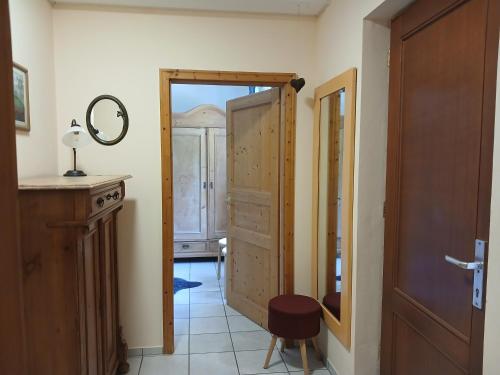 a hallway with a door and a stool in a room at Ferienwohnung Blum in Antweiler