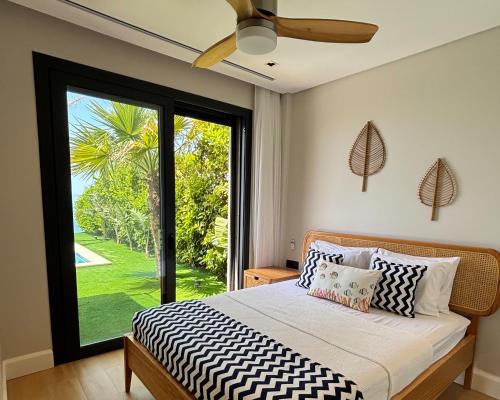 a bedroom with a bed and a large window at Villa Aktürk in Bodrum City