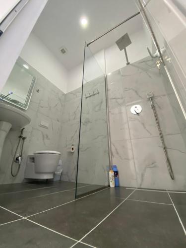 a bathroom with a shower and a toilet at Hotel Restaurant Deso in Shijak