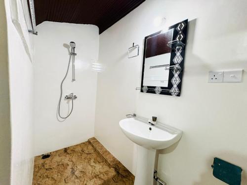 a bathroom with a sink and a shower at TravelLodge Eco in Arugam Bay