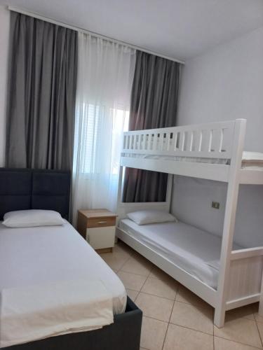 a bedroom with two bunk beds at Vila Familjare Memushi in Ksamil