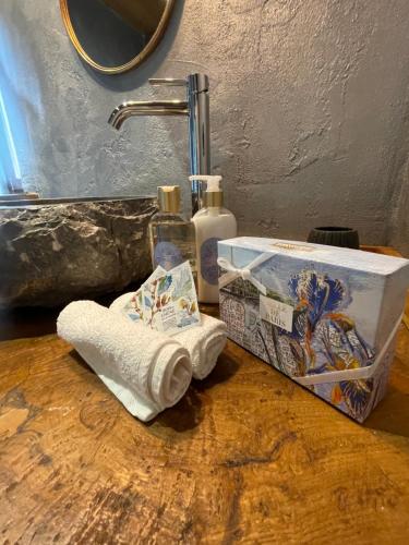 a bathroom counter with a roll of toilet paper and a sink at Casa Vecchia Bed&Breakfast in Bossolasco