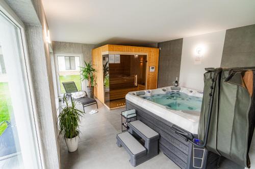 a large bathroom with a large bath tub at Casa DIAMOND LUX&SPA in Sovata