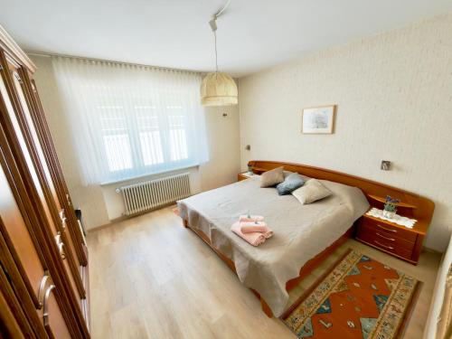 a bedroom with a bed with a pink doll on it at BELVEDERE - Lakeview Apartment 10 min from Lugano in Porza