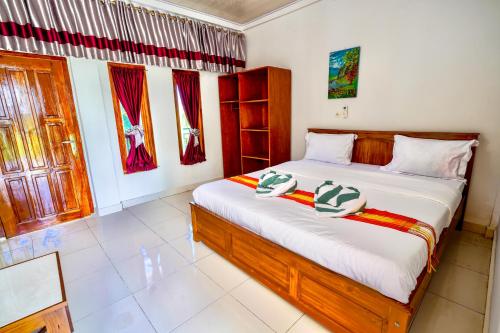 a bedroom with a large bed in a room at Golo Tango Homestay in Labuan Bajo
